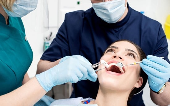 dentist in Burleson with a patient during their dental exam and cleaning treatment