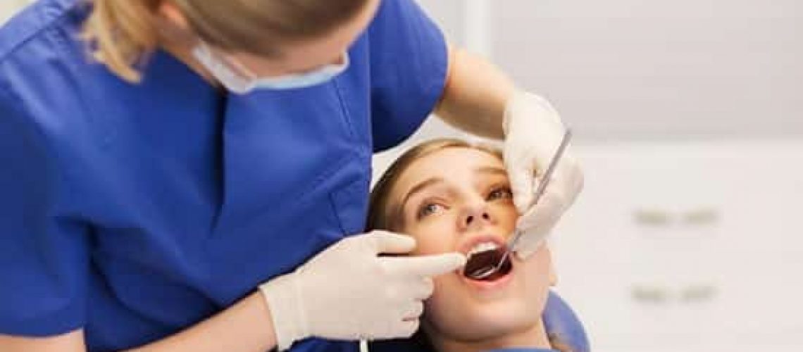 Why are Dental Exams & Cleanings needed our skilled dentist in Burleson, doing dental cleanings and exams on a patient